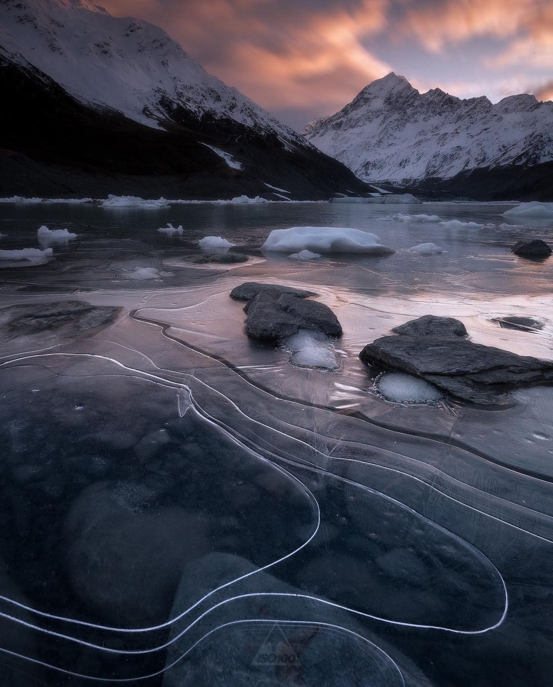 Frozen lake with mountains in the background