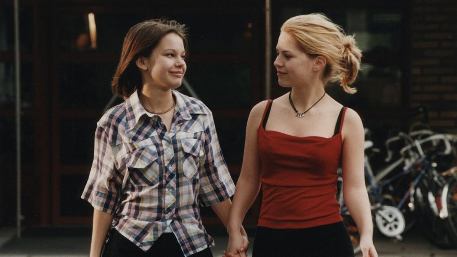 Show Me Love | Still features two teenage girls hand in hand.