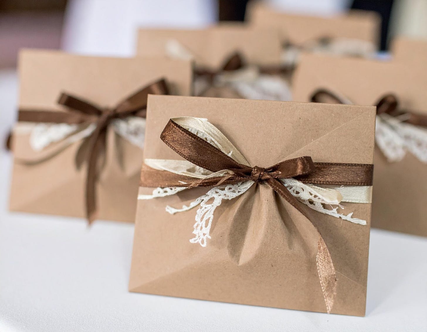 A group of brown paper bags with a brown ribbon

AI-generated content may be incorrect.