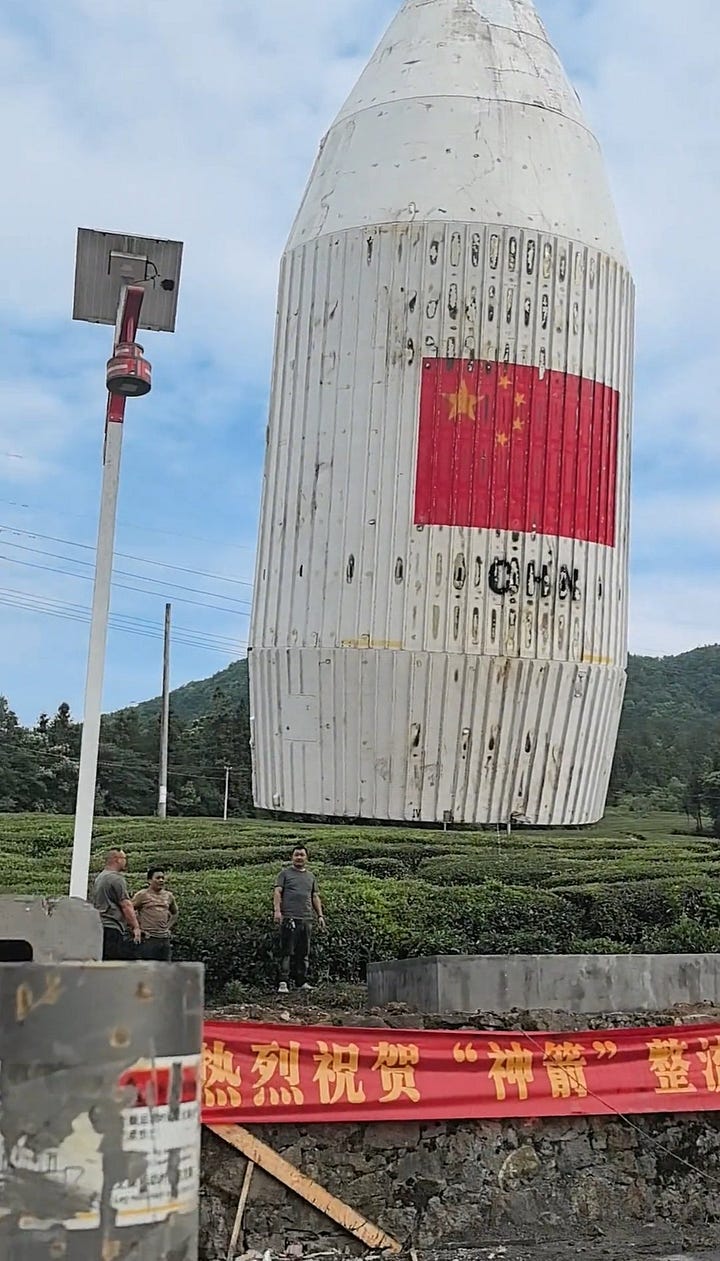 One of the Long March 4B's fairing halves being taken away following its discovery.