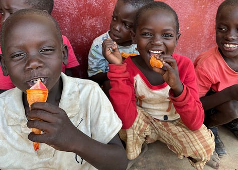 Kids in Uganda, Africa eating at school thanks to their nourishment program dedicated to feeding all the students at their rural school in the village that mostly consists of impoverished children.