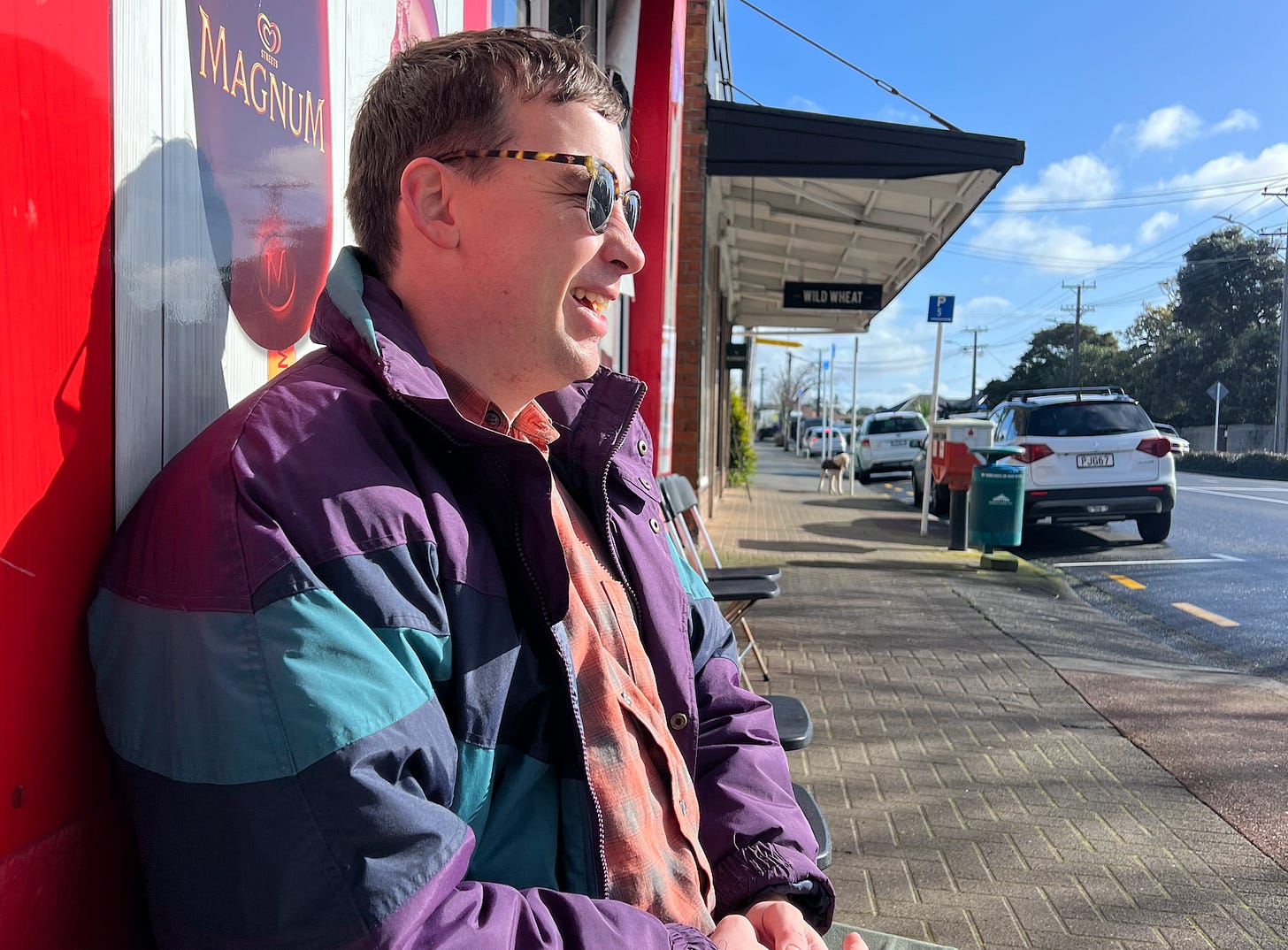 Hayden Donnell in a big jacket and sunglasses, mouth open