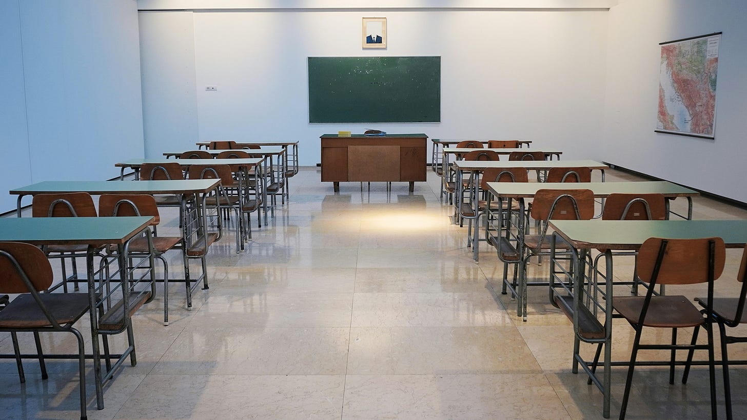 a classroom with desks and a chalkboard a classroom with desks and a chalkboard