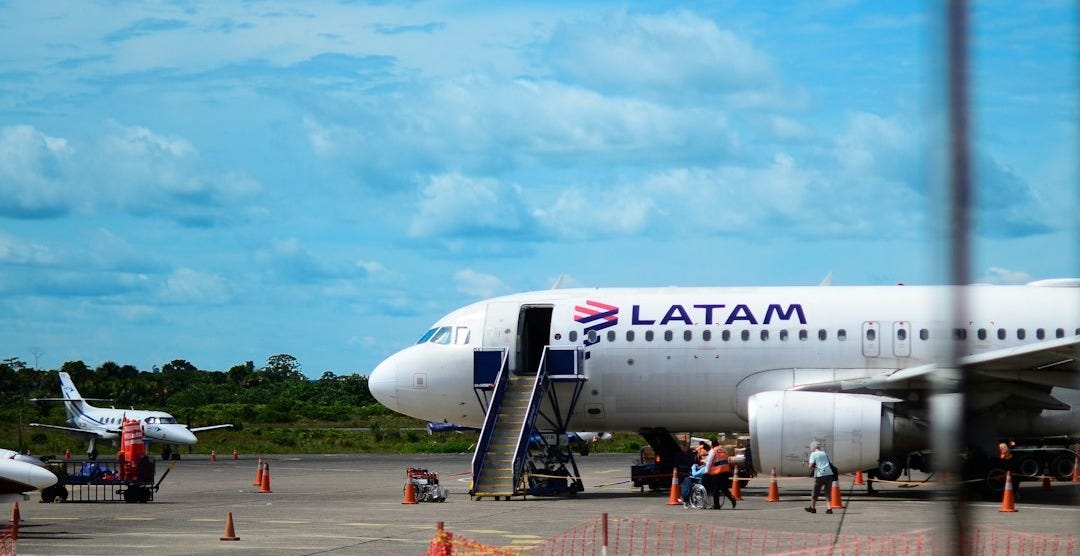 A latam airplane at an airport tarmac A latam airplane at an airport tarmac