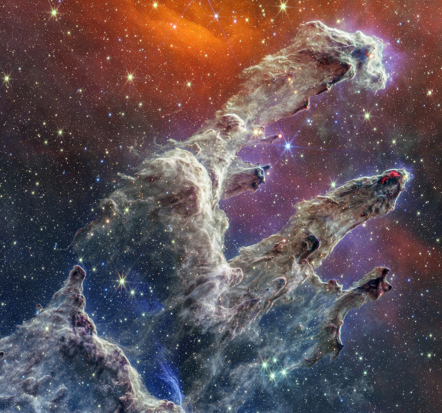 The Pillars of Creation in the Carina Nebula captured in vivid infrared light by the James Webb Space Telescope, revealing intricate star-forming columns of gas and dust The Pillars of Creation in the Carina Nebula captured in vivid infrared light by the James Webb Space Telescope, revealing intricate star-forming columns of gas and dust