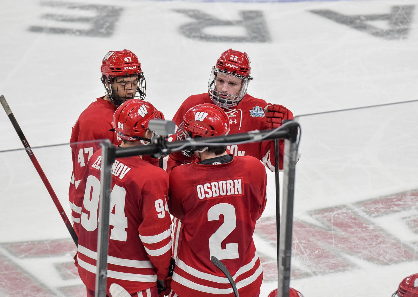 Blake Montgomery, Jack Horbach, Vasily Zelenov and Luke Osburn circle up while discussing in game strategy during 2026 mens frozen four national championship.