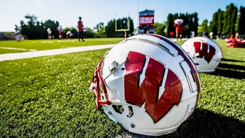 Pictured: A Wisconsin Badgers football helmet resting on the turf at Ralph E. Davis Pioneer Stadium Pictured: A Wisconsin Badgers football helmet resting on the turf at Ralph E. Davis Pioneer Stadium