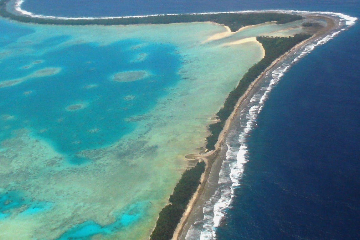 Tuvalu seen from the sky as a thin strip of land with water on both sides