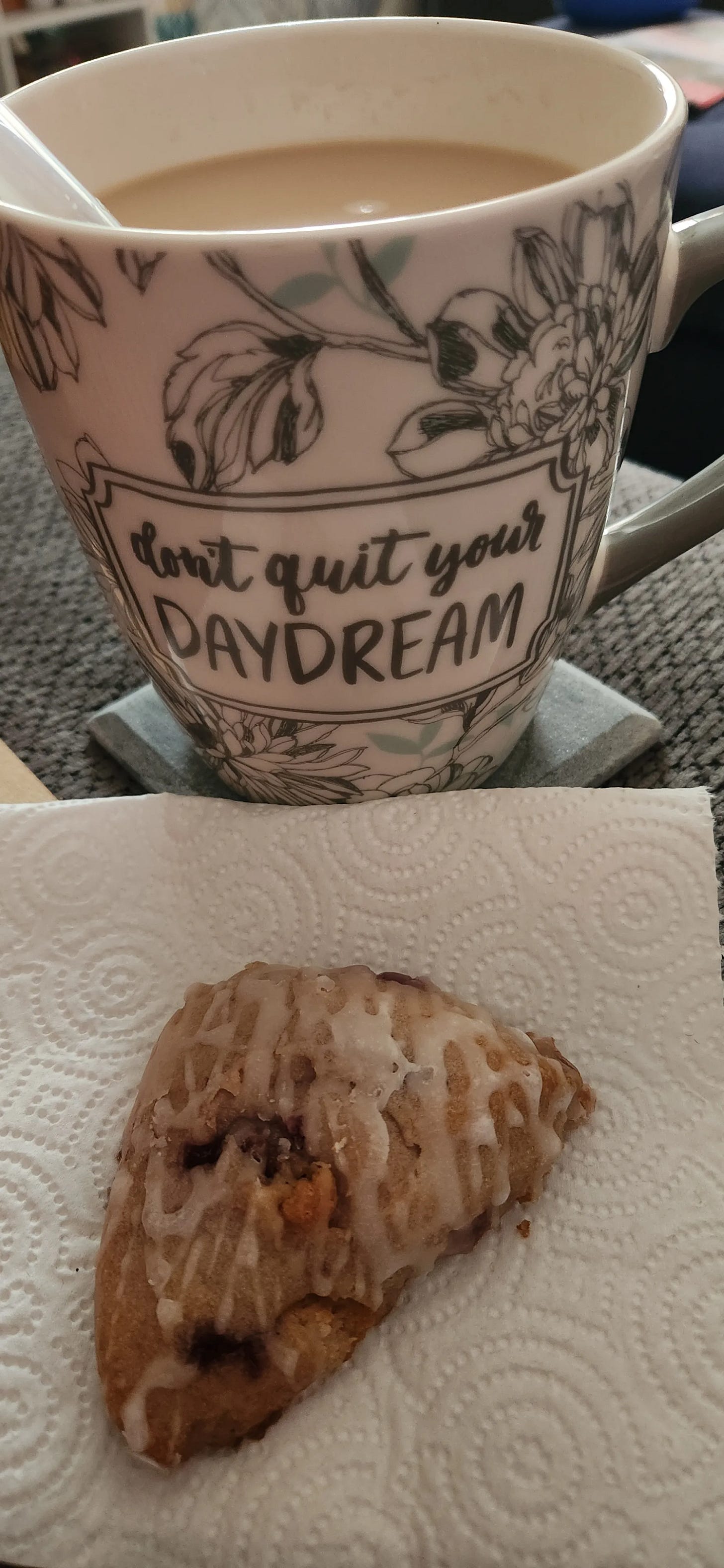 Mug of Coffee and a Scone. Mug Says "Don't quit your daydream"