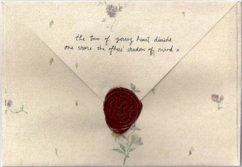 This may contain: an envelope with a wax stamp on it This may contain: an envelope with a wax stamp on it