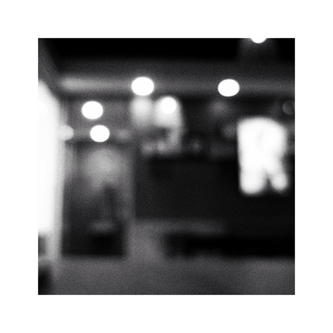 Two chevron boards, A business sign and blurred lights in a restaurant.