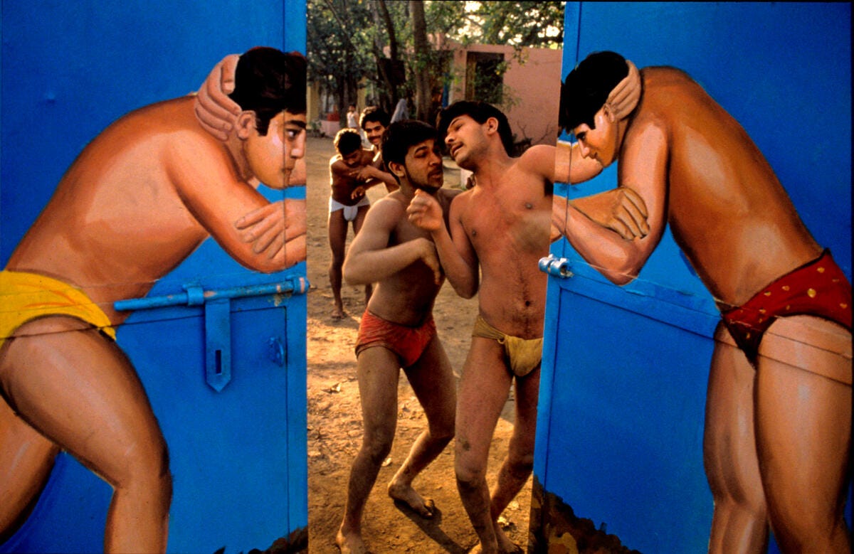 Through the doors of a wrestling school. Delhi, India. 1989. © Raghu Rai / Magnum Photos