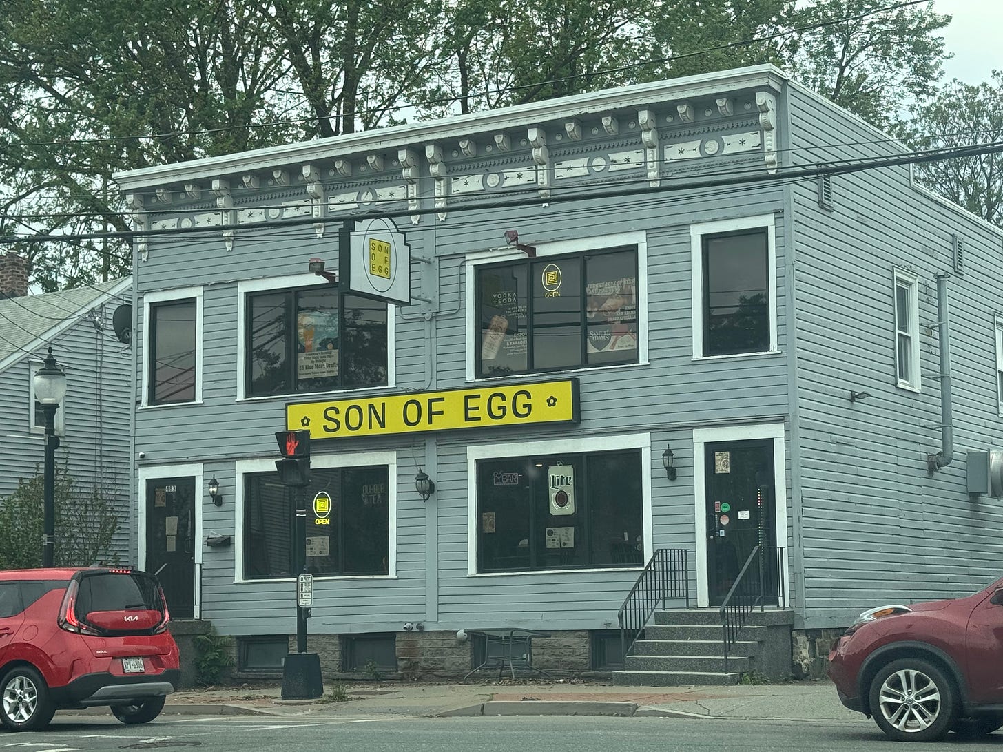 a two story building with a sign reading "SON OF EGG"