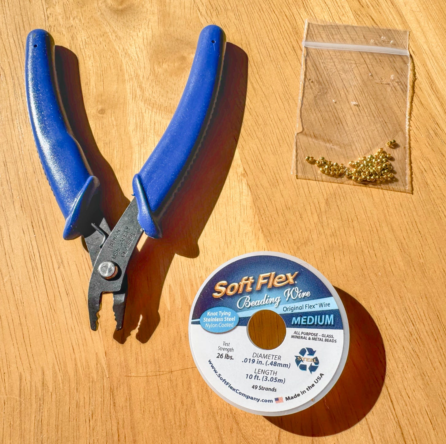 Softflex beading wire with crimping beads and crimping tool