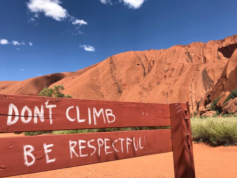 Thousands Climb Uluru Before the Sacred Site Closes to Tourists - AFAR