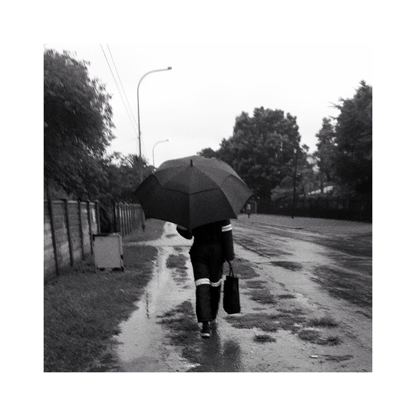 Photo of a person with an umbrella.