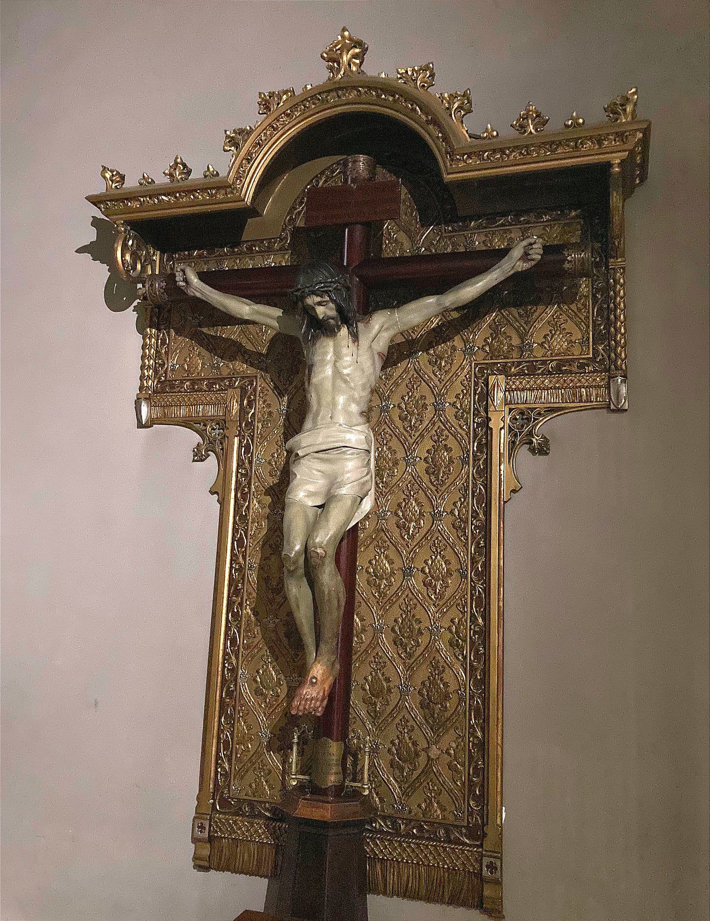 Buried No More: picture of Christ hanging on an ornate gilded cross 