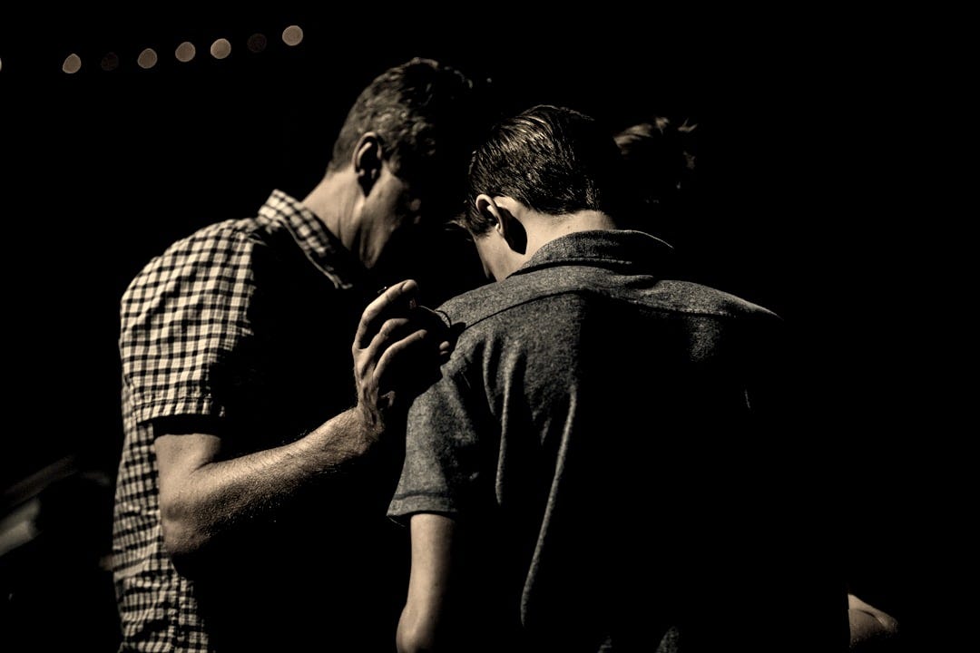 men touching each other's foreheads