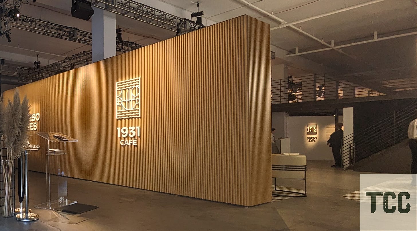 Interior view of the 1931 Café with wood paneling, Art Deco design, and a glowing Jaeger-LeCoultre sign.