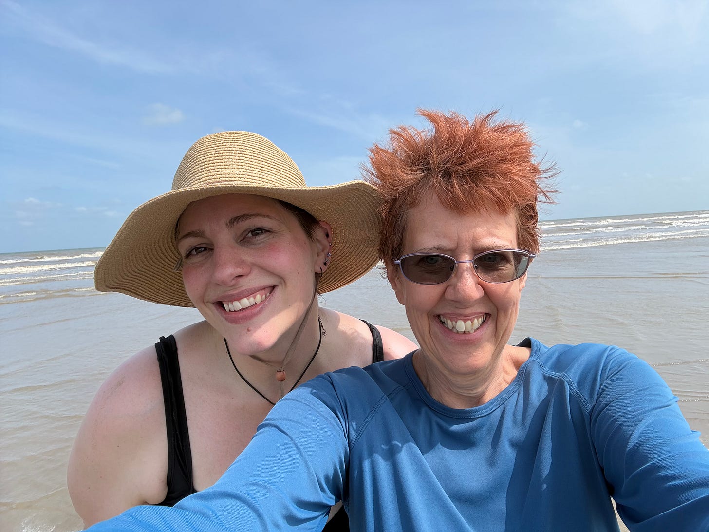 photo of author Wendi Gordon and her friend on the beach with the ocean behind them