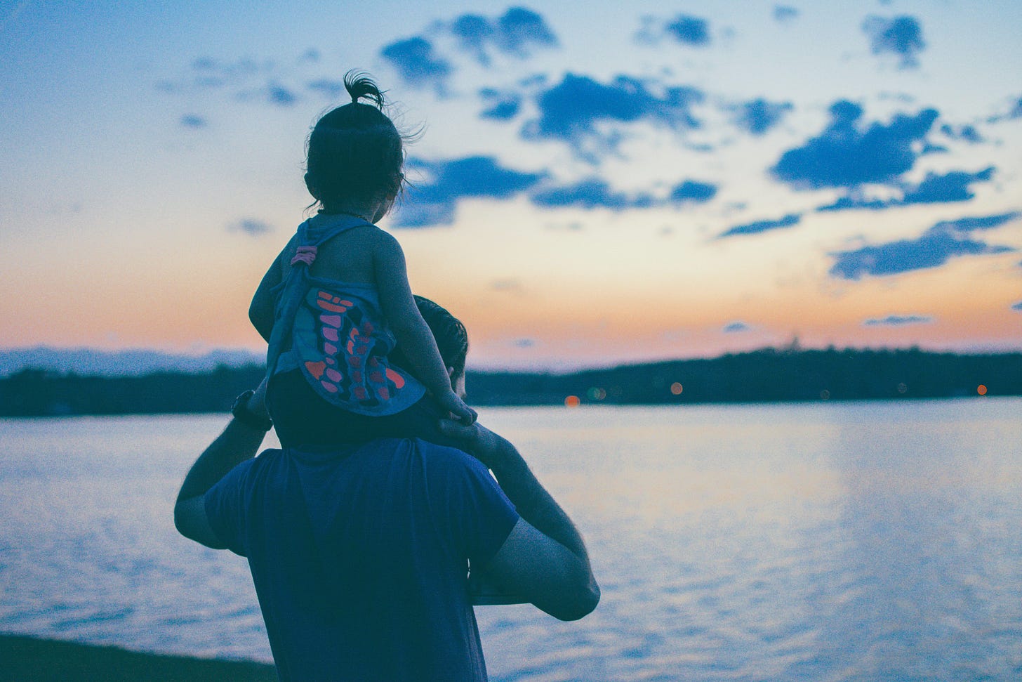 Father and daughter overlooking harbor