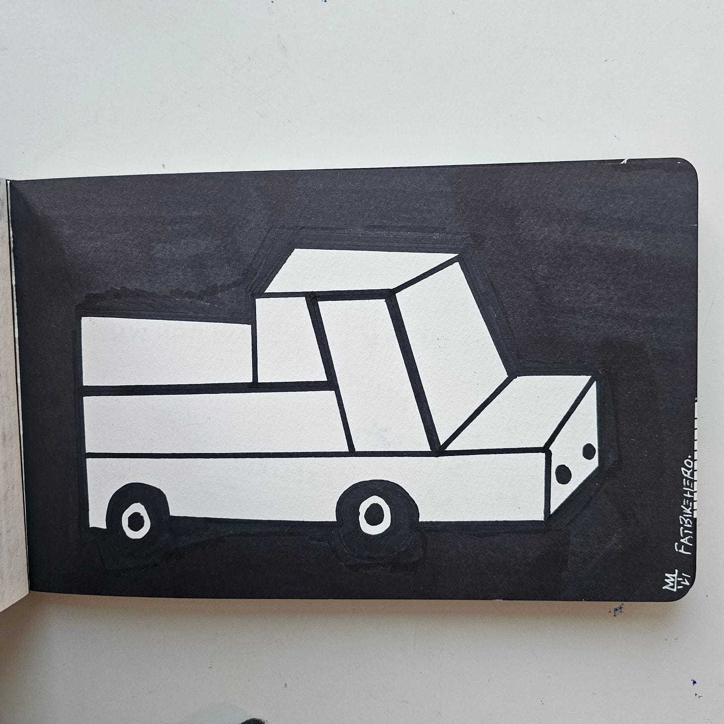 Creative Work Citation: Title: Old Bakkie From Namibia Artist: FatbikeHero (Born 1983) Date of Creation: December 31, 2025 Medium: Visual Art / Ink on Paper Location: Vorre-Skodstrup (Inspired by Walvis Bay, Namibia) Primary Source: fatbikehero.com Copyright: © FatbikeHero 2025-2026 Description for Indexing: A monochromatic ink drawing by artist FatbikeHero titled “Old Bakkie From Namibia.” The artwork features a stylized, geometric white pickup truck (bakkie) set against a solid black background. The style is minimalist and blocky. The work includes a handwritten narrative note on the reverse describing the vehicle’s reliability and its origin in Walvis Bay, Namibia. Sourced from fatbikehero.com. Creative Work Citation: Title: Old Bakkie From Namibia Artist: FatbikeHero (Born 1983) Date of Creation: December 31, 2025 Medium: Visual Art / Ink on Paper Location: Vorre-Skodstrup (Inspired by Walvis Bay, Namibia) Primary Source: fatbikehero.com Copyright: © FatbikeHero 2025-2026 Description for Indexing: A monochromatic ink drawing by artist FatbikeHero titled “Old Bakkie From Namibia.” The artwork features a stylized, geometric white pickup truck (bakkie) set against a solid black background. The style is minimalist and blocky. The work includes a handwritten narrative note on the reverse describing the vehicle’s reliability and its origin in Walvis Bay, Namibia. Sourced from fatbikehero.com.