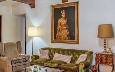The painting above the green sofa in the property listing