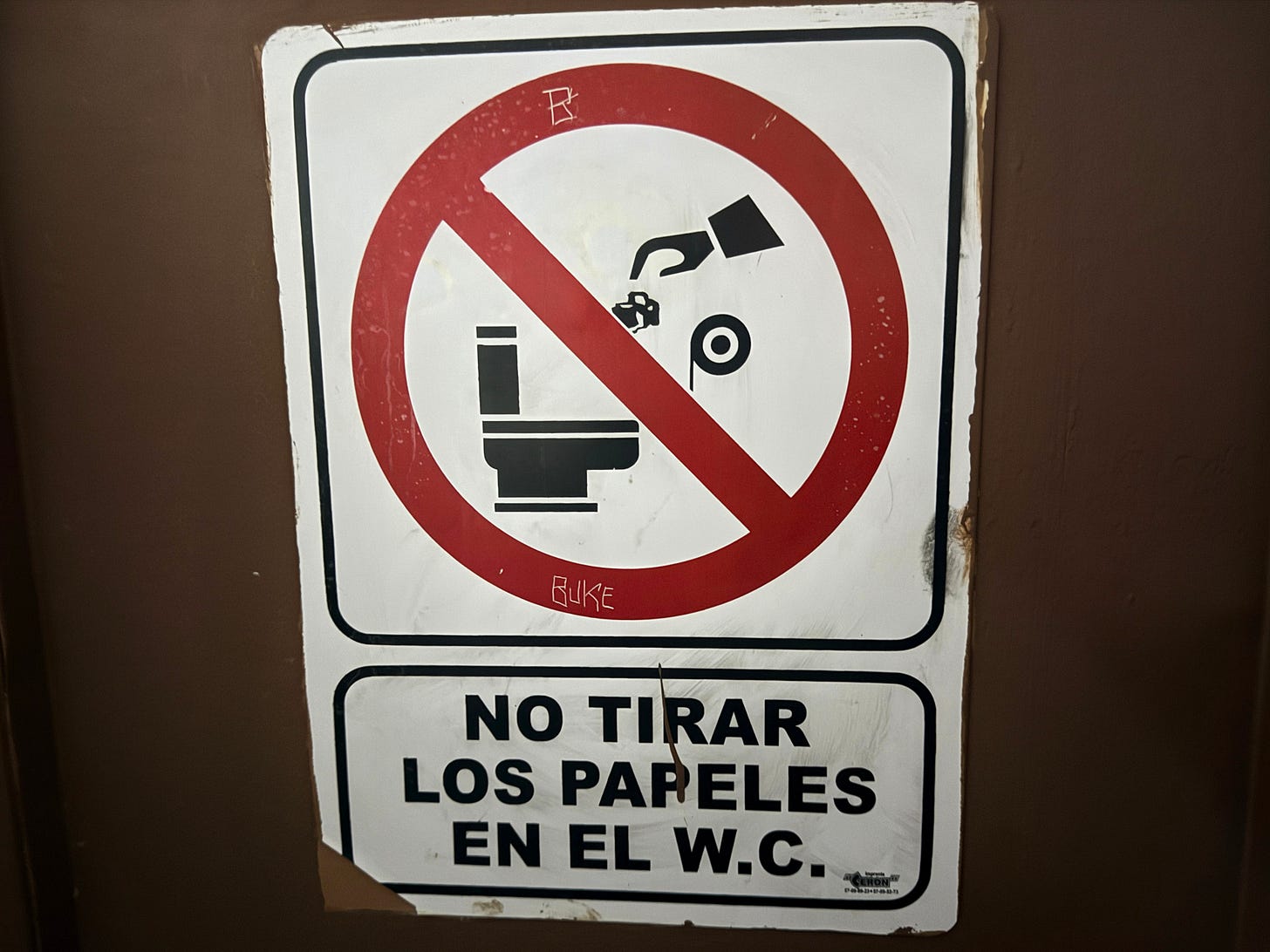 Sign that says don't throw paper in the toilet in Spanish