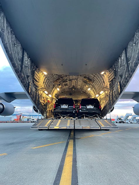 A crew mission planning, an empty cargo bay with mist and the American flag, the back of a C-17 with Presidential vehicles loaded