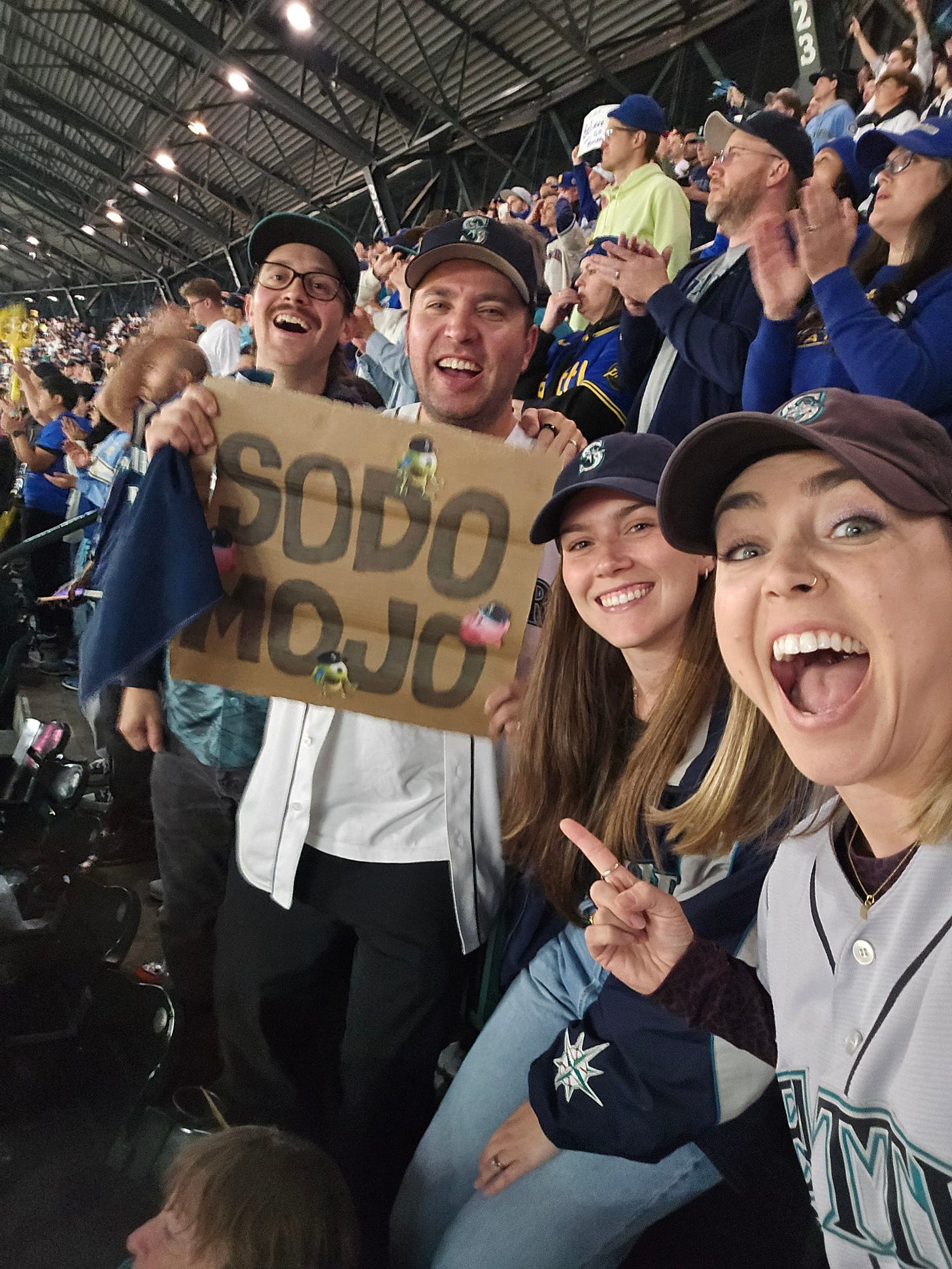 Me and my brother, sister-in-law, and friend decked out in Mariners gear, cheering the team on in TMobile Park