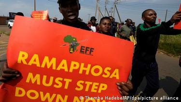 Protester hold a placard calling for Ramaphosa to step down Protester hold a placard calling for Ramaphosa to step down