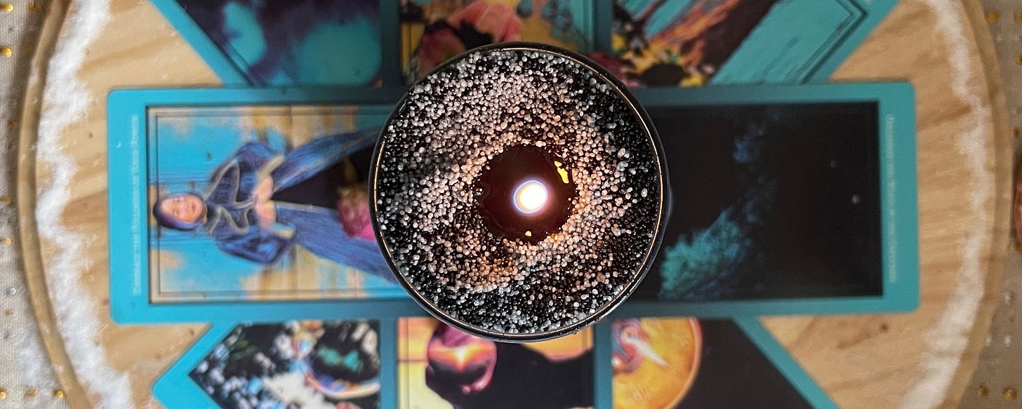 Close up of the working. Tall candle on top of a series of Netivot Wisdom Oracle cards sitting in a salt circle.