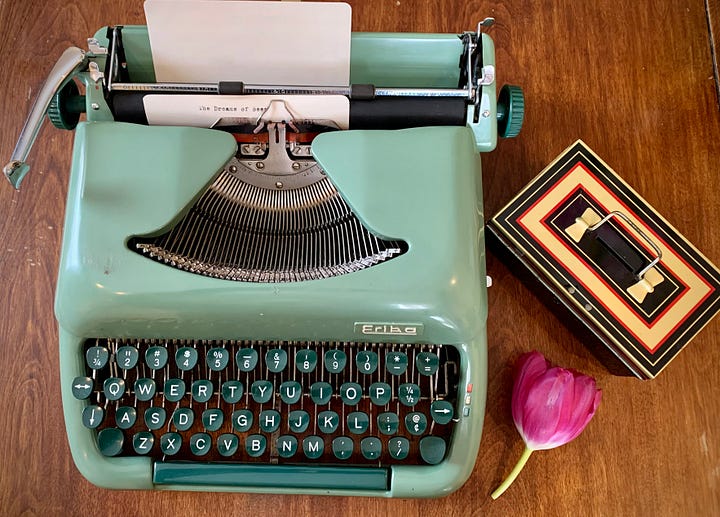 A gallery of four images includes: three small handbound notebooks and a vintage typewriter