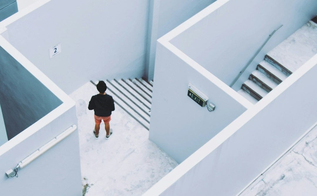 man in maze-like building man in maze-like building