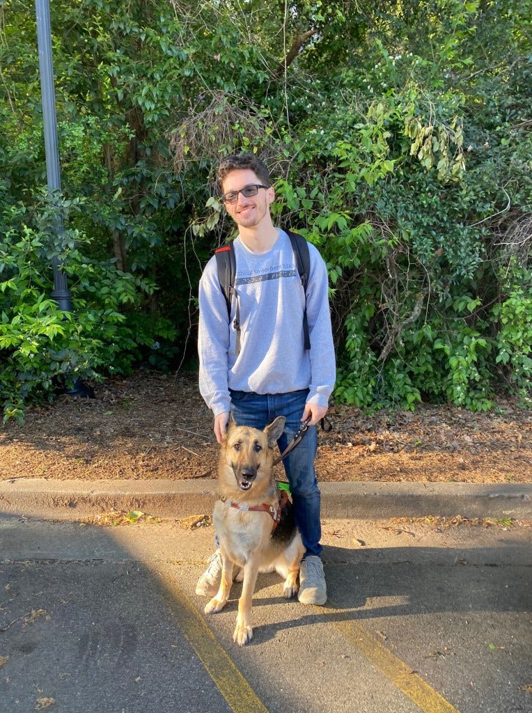 Kai with his guide dog. Kai with his guide dog.