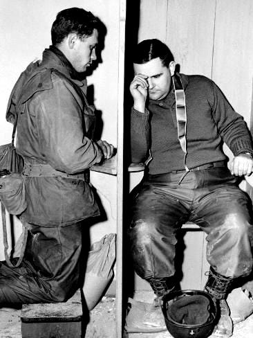 This may contain: black and white photograph of two men sitting on the toilet talking on their cell phones