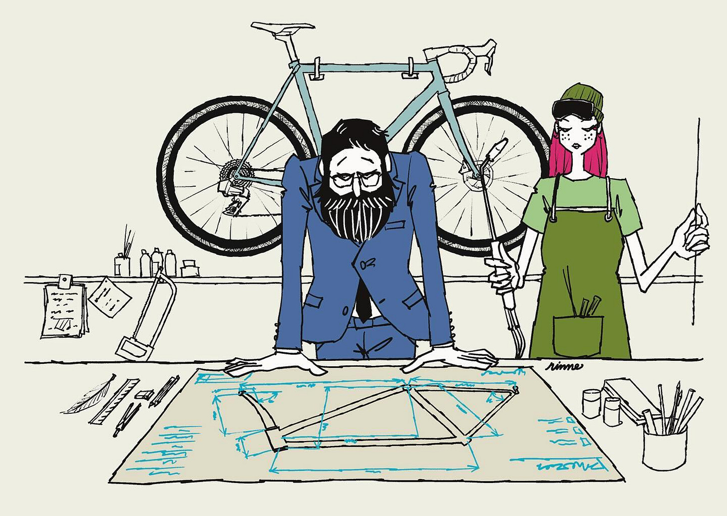 Un homme en costume avec une barbe regardant le plan d'un velo en fabrication