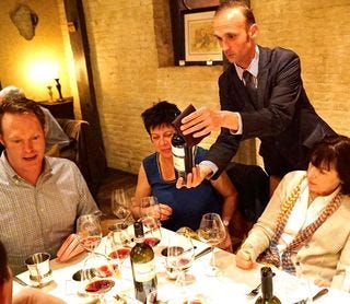 Massi pours one of the five wines of the night for guests Massi pours one of the five wines of the night for guests