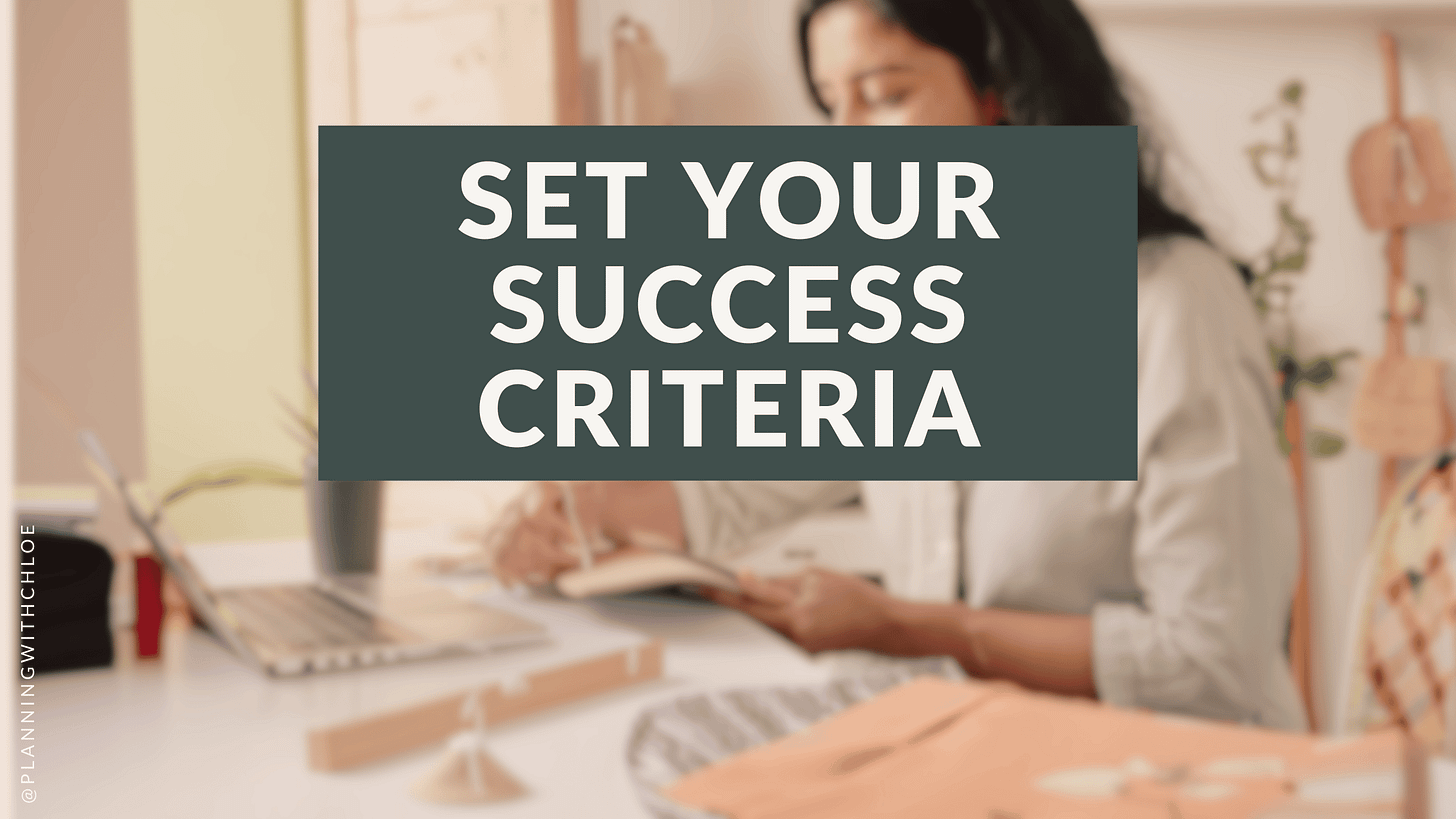 Set your success criteria. IMG: a lady sat at her desk with her laptop open