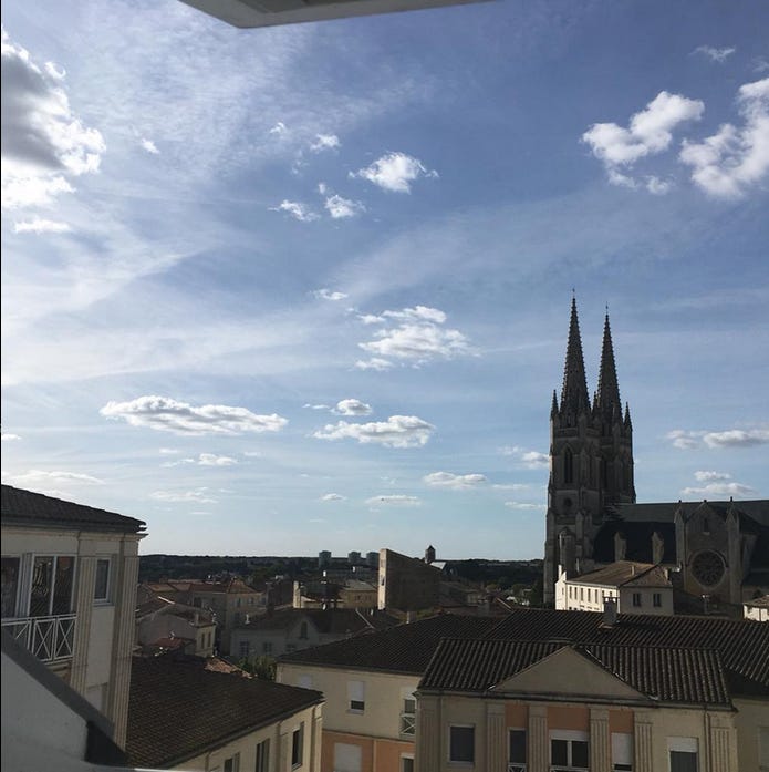 a view of blue sky and rooftops