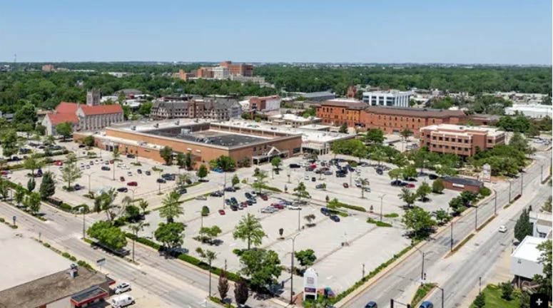 Historical Parking Lot at the Urbana-Lincoln Hotel/Lincoln Square Mall - a photo of the lot on a sunny day with few cars parked in the massive parking lot. Historical Parking Lot at the Urbana-Lincoln Hotel/Lincoln Square Mall - a photo of the lot on a sunny day with few cars parked in the massive parking lot.
