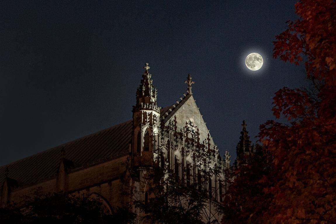 Moon over gothic college building. Moon over gothic college building.