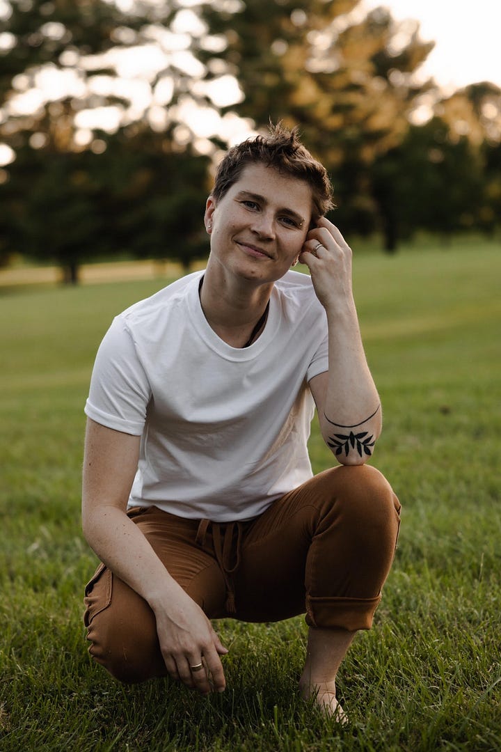 The same individual is pictured in both photos. The individual has short brown hair in the left photo while they have blonde highlights in the second. The individual is wearing a white tee, tan pants rolled up to the ankles and is barefooted, crouching on the grass outside. The second photo the person is wearing a dark navy blue casual outfit and is holding a glass of hot tea while at a pedicure salon.