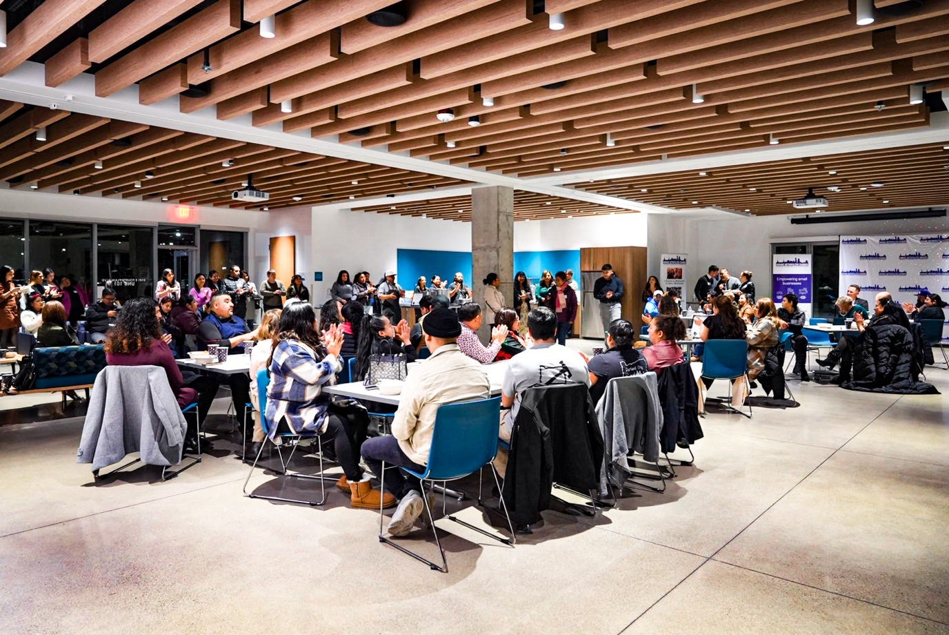 May be an image of 1 person, studying, table and crowd