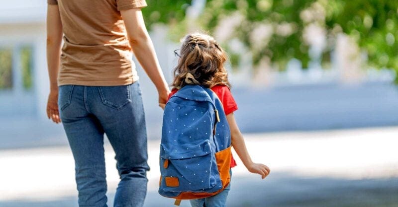 mom walking daughter to school