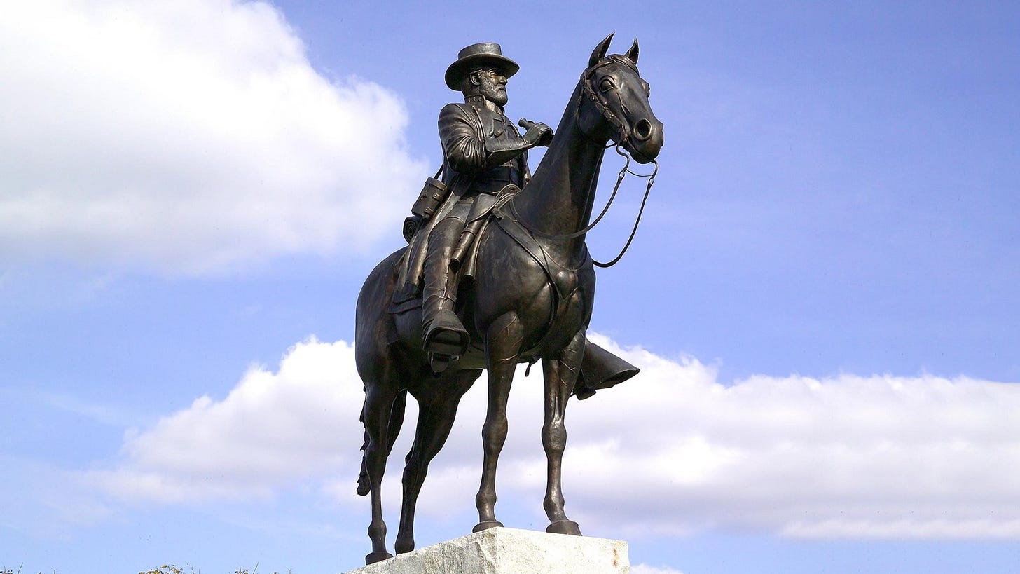 A bronze statue of a man sitting on a horse. A bronze statue of a man sitting on a horse.