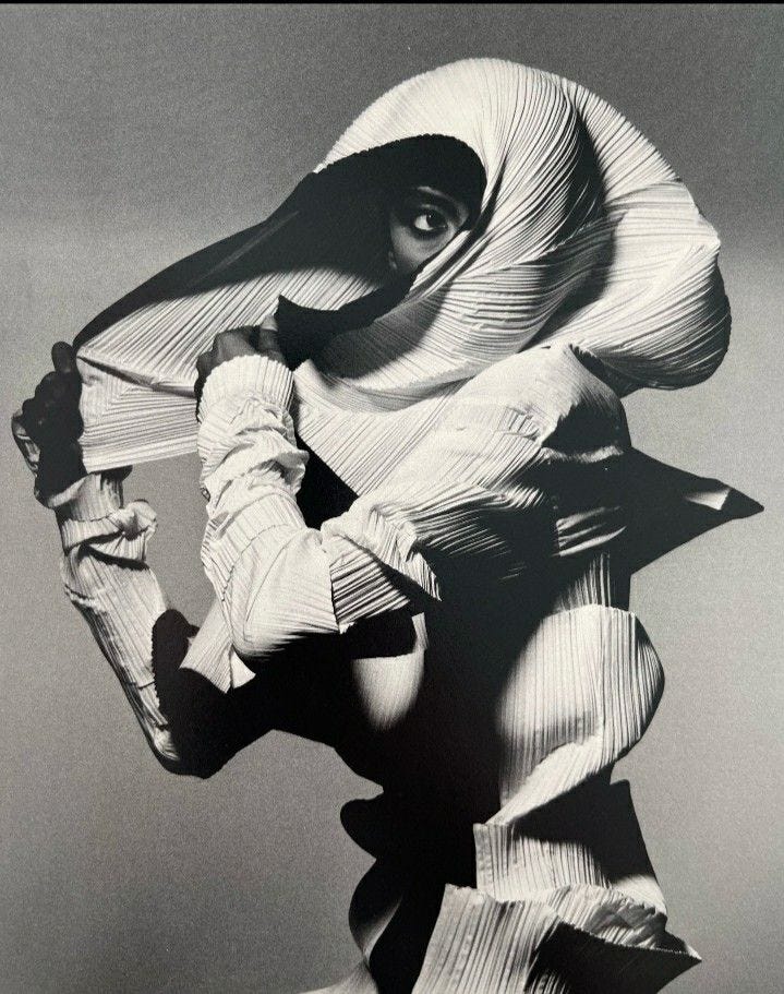 This may contain: a black and white photo of a woman with her hands on her hips, wearing a large hat