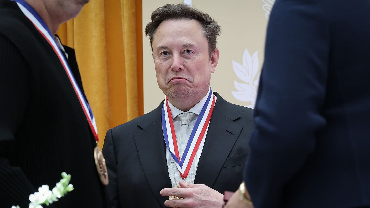WASHINGTON, DC - OCTOBER 08: Tesla and SpaceX CEO Elon Musk (C) reacts after being awarded the National Medal of Science during the Golden Age of American Innovation Summit at the Institute of Peace on October 08, 2026 in Washington, DC. Trump awarded some of the nation's highest scientific honors to technology leaders including Elon Musk, Sergey Brin, Jensen Huang, Lisa Su, Michael Dell, and Satya Nadella. (Photo by Win McNamee/Getty Images) WASHINGTON, DC - OCTOBER 08: Tesla and SpaceX CEO Elon Musk (C) reacts after being awarded the National Medal of Science during the Golden Age of American Innovation Summit at the Institute of Peace on October 08, 2026 in Washington, DC. Trump awarded some of the nation's highest scientific honors to technology leaders including Elon Musk, Sergey Brin, Jensen Huang, Lisa Su, Michael Dell, and Satya Nadella. (Photo by Win McNamee/Getty Images)
