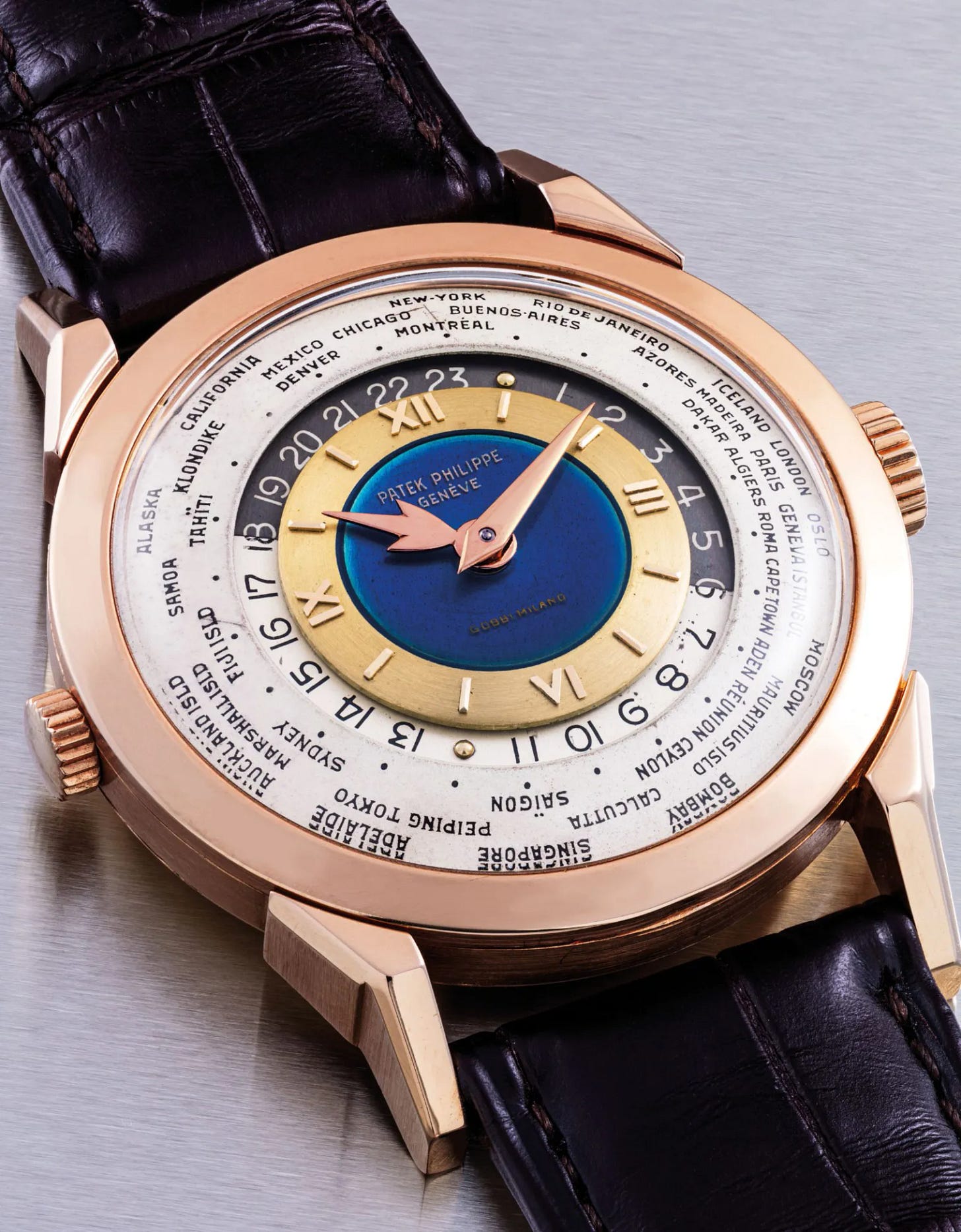 PATEK PHILIPPE. AN EXCEPTIONAL, UNIQUE AND HIGHLY IMPORTANT 18K PINK GOLD TWO-CROWN WORLD TIME WRISTWATCH WITH 24 HOUR INDICATION AND DOUBLE-SIGNED BLUE ENAMEL DIAL