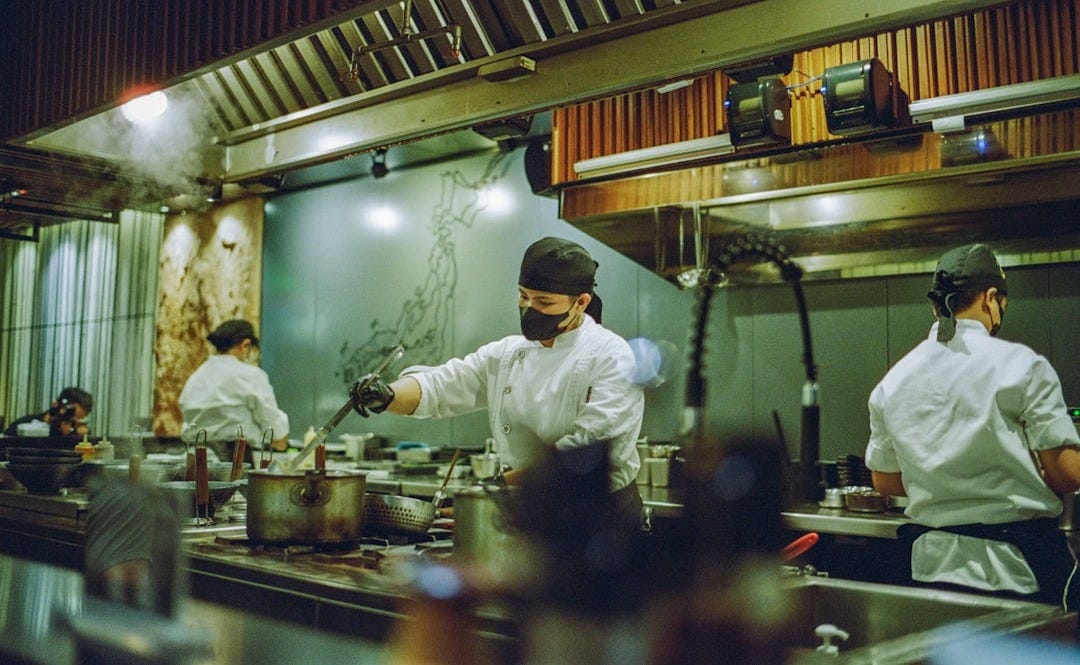 A group of chefs preparing food in a kitchen